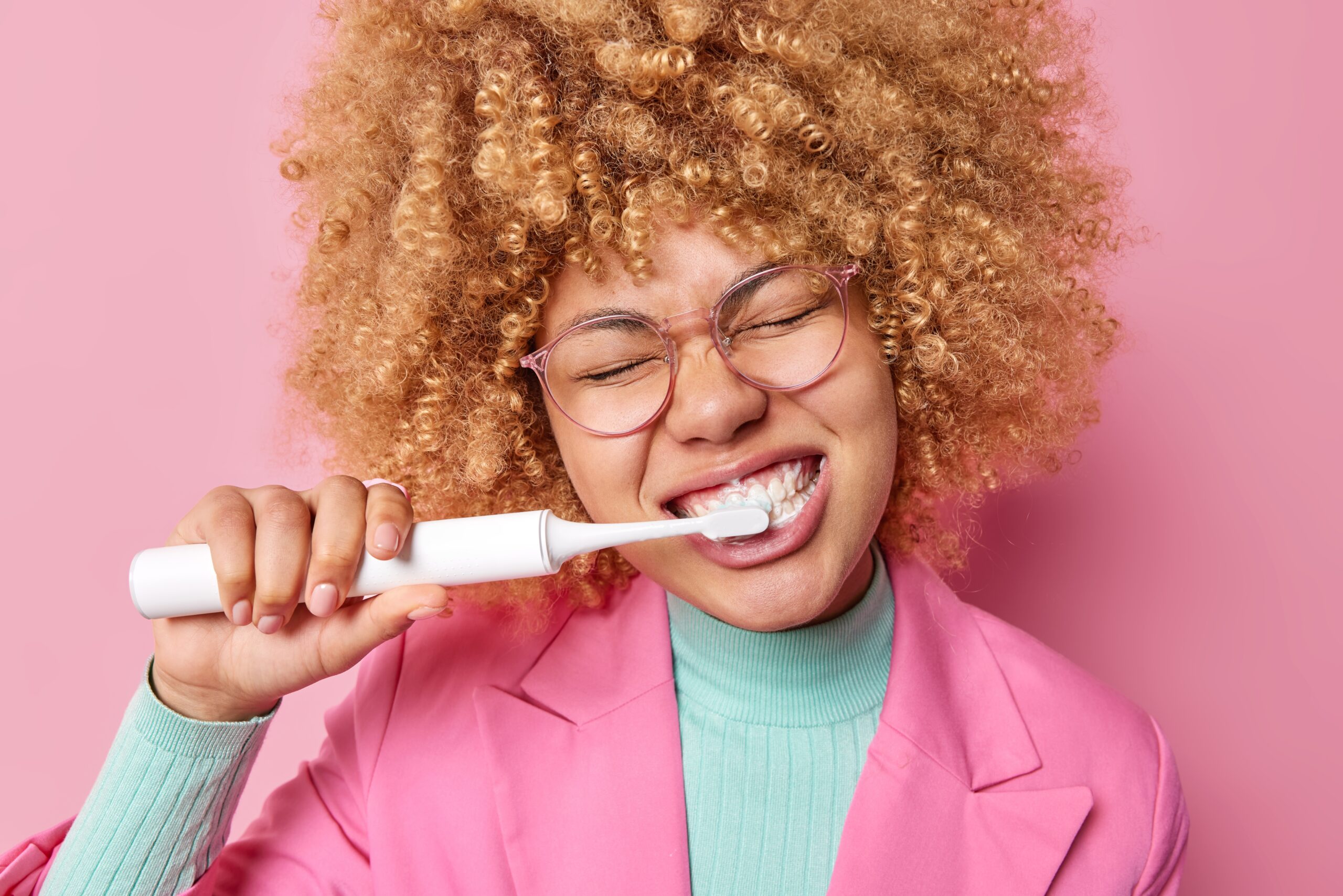 Curly hair lady brushing teeth Curly hair lady brushing teeth